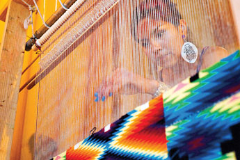 Textile artist Melissa Cody gives a weaving demonstration during the Life Preservation Summit at Diné College in Tsaile Thursday.  © 2011 Gallup Independent / Cable Hoover 
